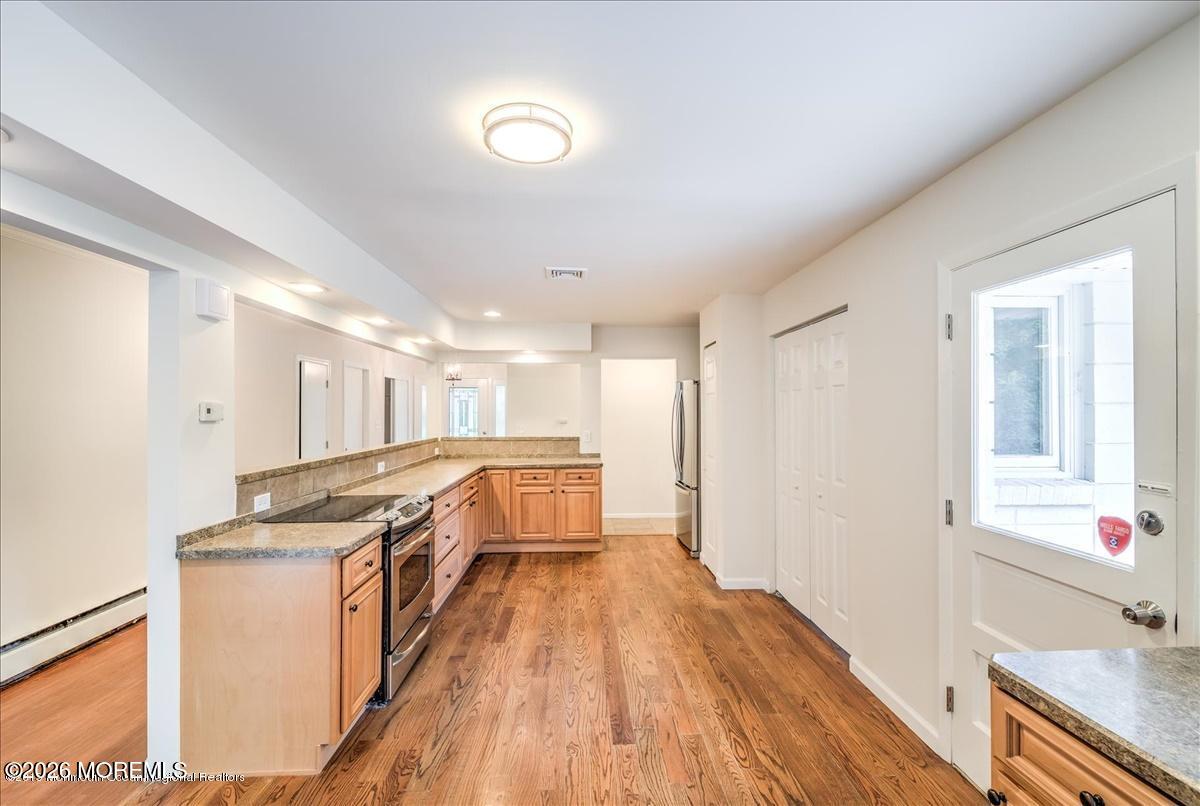 699 Aldrich Road Howell, NJ 07731 - Photo 12 of 23 a view of a kitchen with a sink and wooden floor