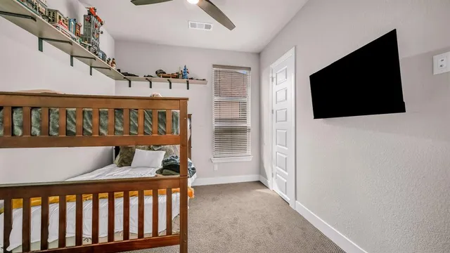 a bedroom with furniture and flat screen tv