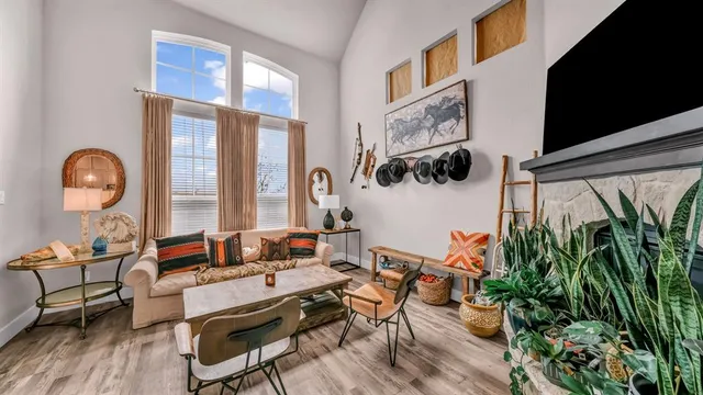 a living room with furniture and a potted plant