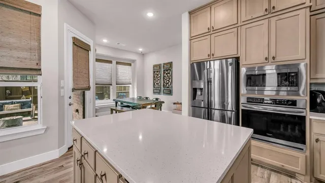 a kitchen with stainless steel appliances a refrigerator sink and microwave