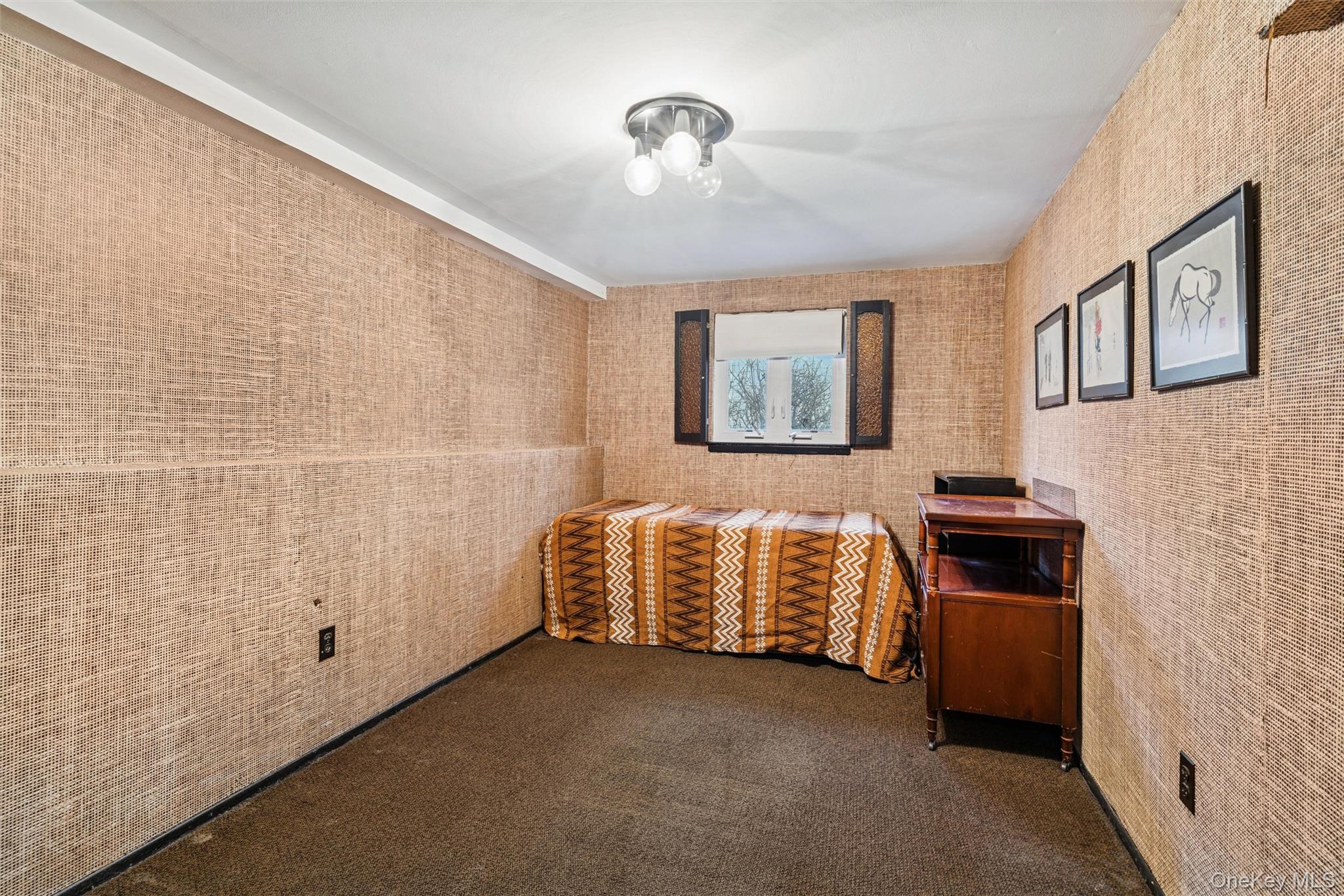 1864 Cynthia Lane Merrick, NY 11566 - Photo 22 of 33 a room with a bed and a chandelier