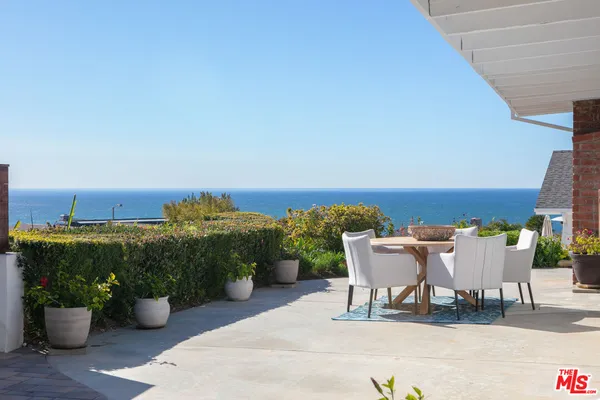 a view of a patio with couches and potted plants