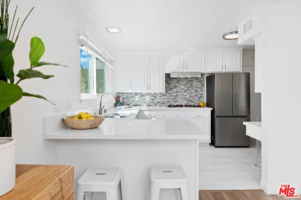 a kitchen with a sink and refrigerator