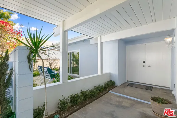 a backyard of a house with table and chairs