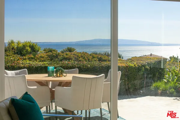 a view of a chairs and table in patio