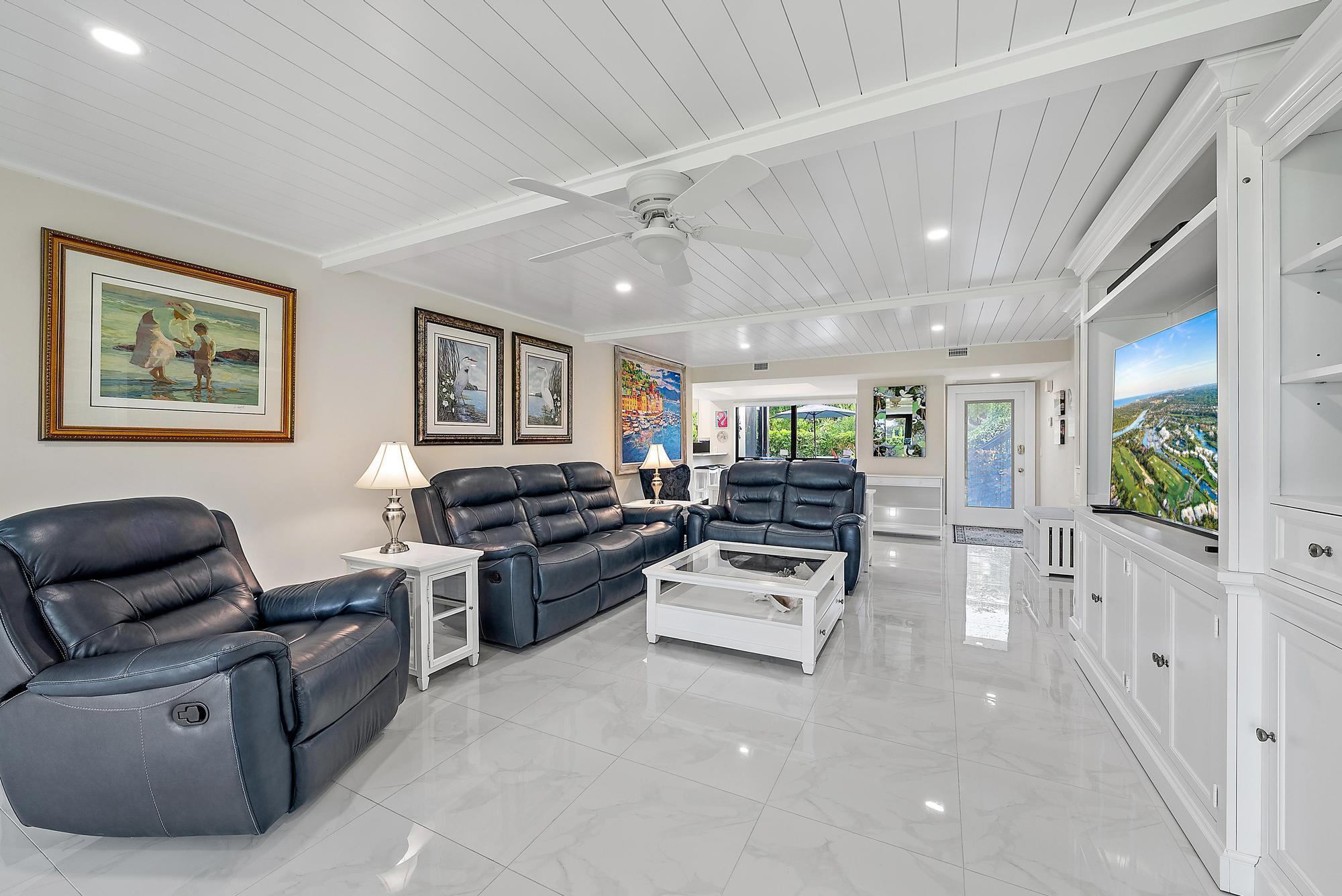 3693 Quail Ridge Drive, Unit BOBWHITE B Boynton Beach, FL 33436 - Photo 11 of 39 a living room with furniture and a flat screen tv