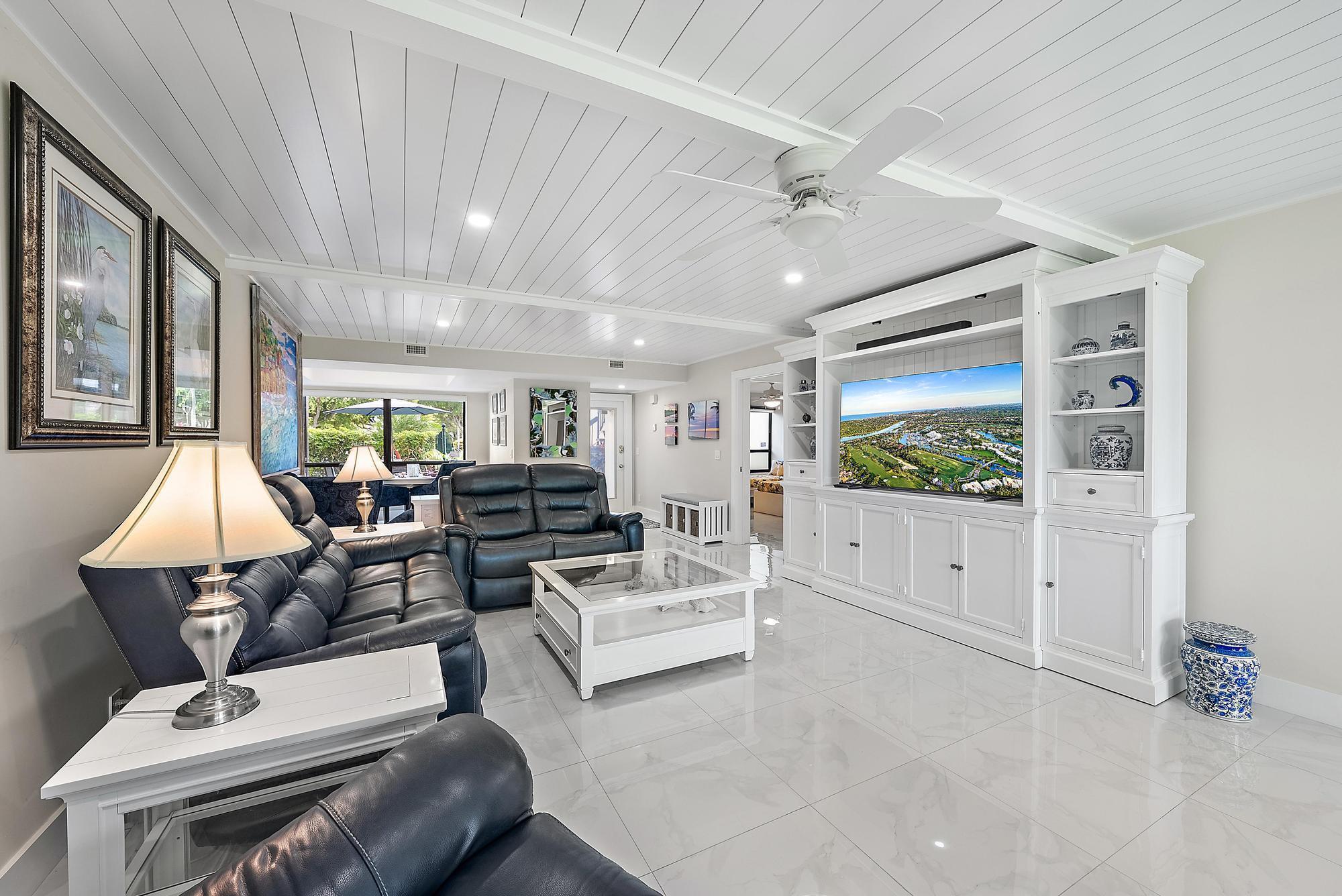 3693 Quail Ridge Drive, Unit BOBWHITE B Boynton Beach, FL 33436 - Photo 12 of 39 a living room with furniture and a large window