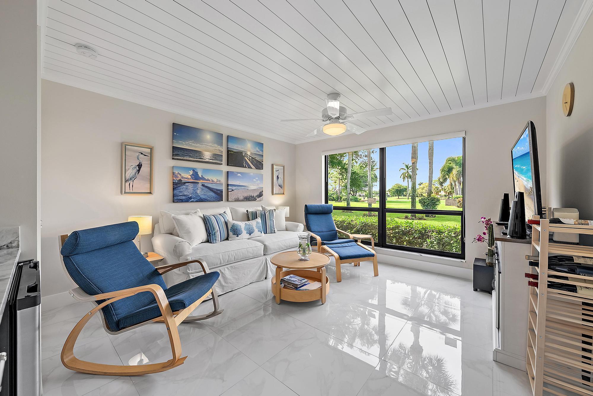 3693 Quail Ridge Drive, Unit BOBWHITE B Boynton Beach, FL 33436 - Photo 14 of 39 a living room with furniture and a floor to ceiling window