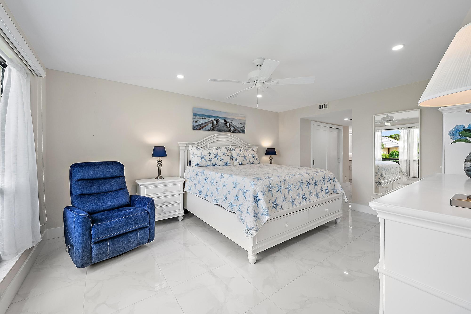 3693 Quail Ridge Drive, Unit BOBWHITE B Boynton Beach, FL 33436 - Photo 17 of 39 a bedroom with a bed and a couch