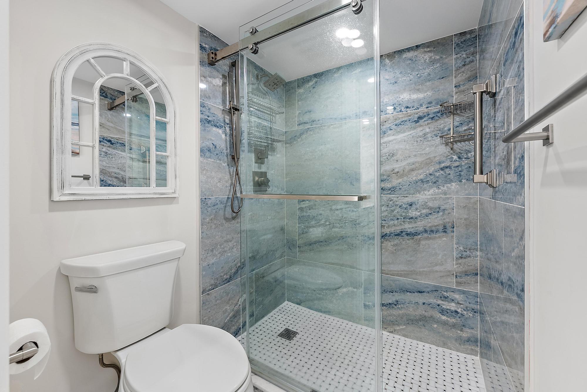 3693 Quail Ridge Drive, Unit BOBWHITE B Boynton Beach, FL 33436 - Photo 21 of 39 a bathroom with a toilet and a shower