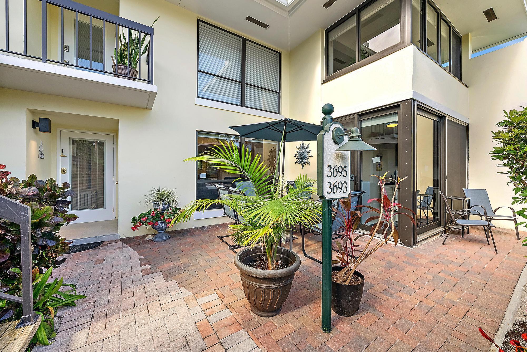 3693 Quail Ridge Drive, Unit BOBWHITE B Boynton Beach, FL 33436 - Photo 27 of 39 a view of a chairs and tables in the patio