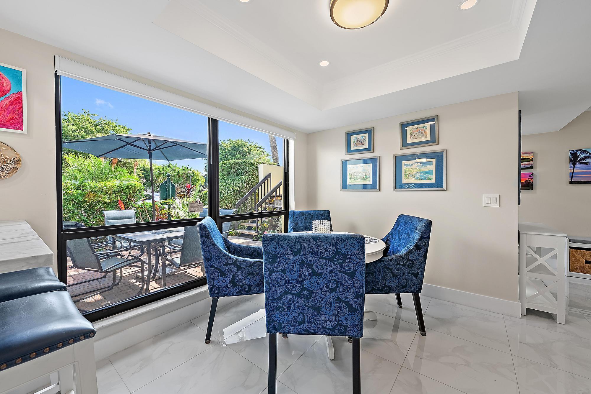 3693 Quail Ridge Drive, Unit BOBWHITE B Boynton Beach, FL 33436 - Photo 7 of 39 a view of a dining room with furniture window and wooden floor