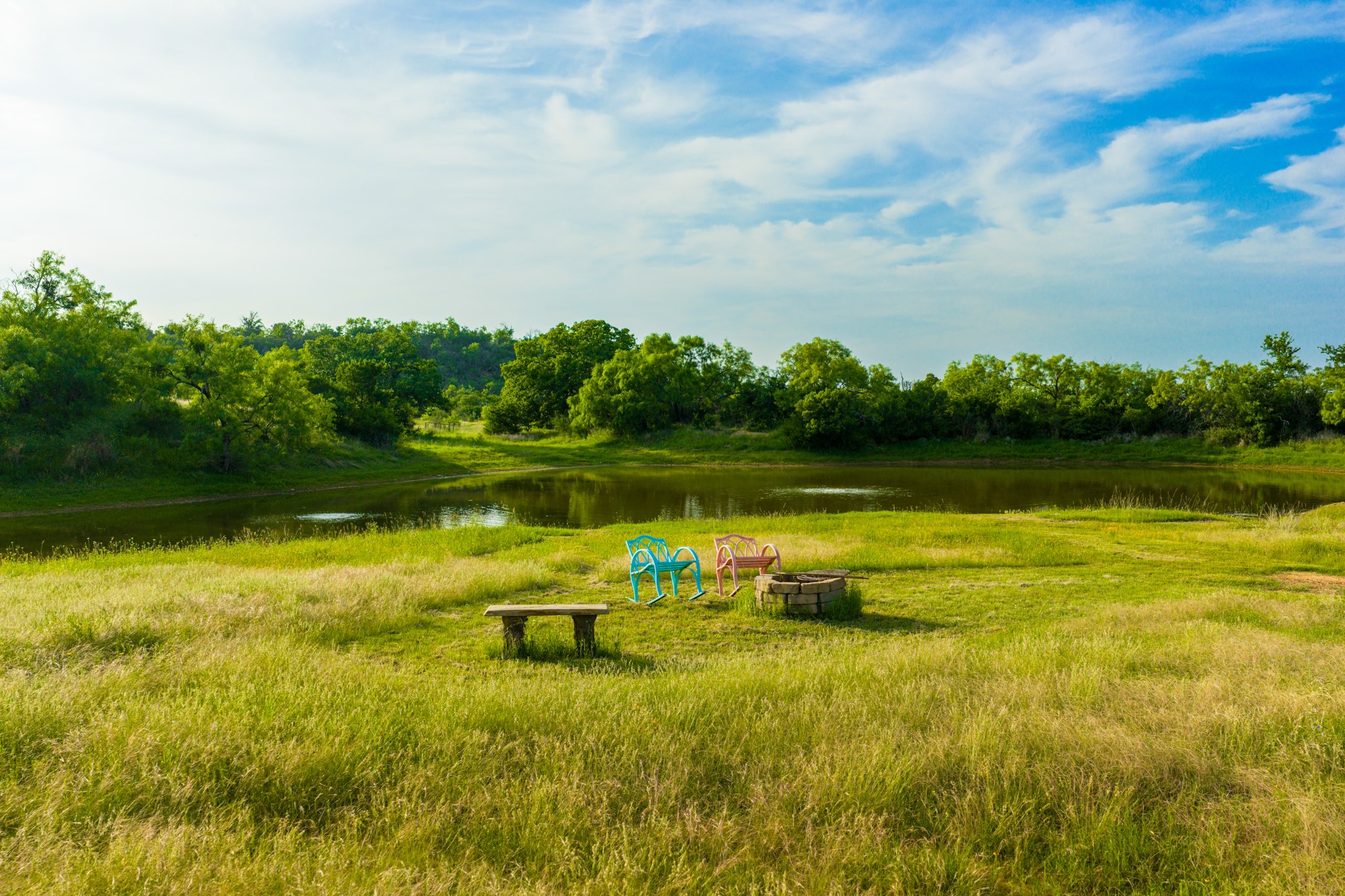 11079 Cr 266 Rochelle Tx 76872 Rochelle, TX 76872 - Photo 2 of 40 Expansive green space featuring a water pond, mature trees, and an open sky