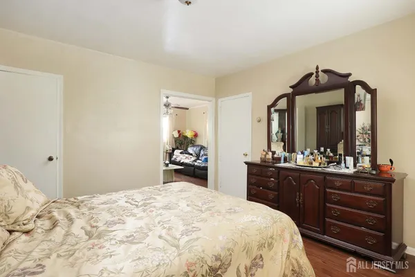 a spacious bedroom with a bed and a dresser