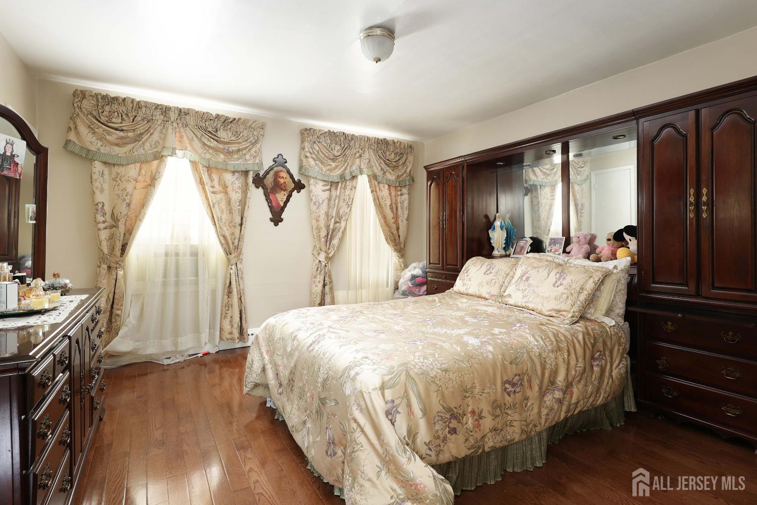 676 Johnstone Street Perth Amboy, NJ 08861 - Photo 15 of 22 a spacious bedroom with a bed and a dresser