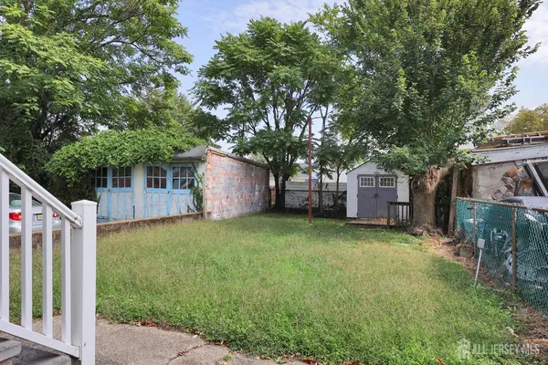 a front view of a house with garden and plants
