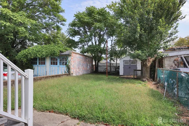 a front view of a house with garden and plants