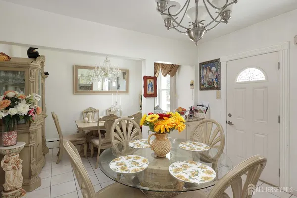 a dining room with furniture a chandelier and wooden floor