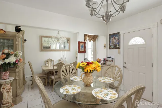 a dining room with furniture a chandelier and wooden floor