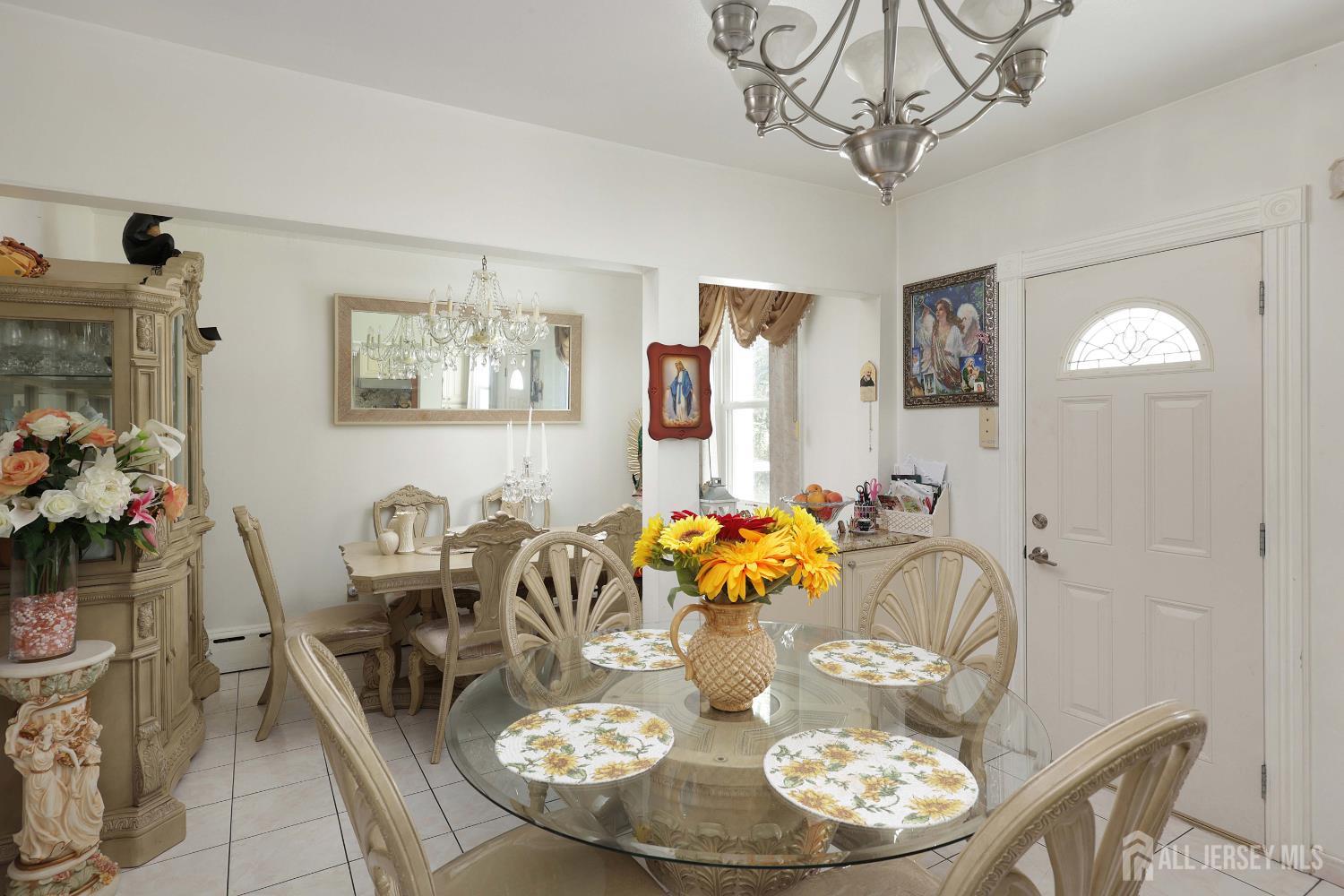 676 Johnstone Street Perth Amboy, NJ 08861 - Photo 10 of 22 a dining room with furniture a chandelier and wooden floor