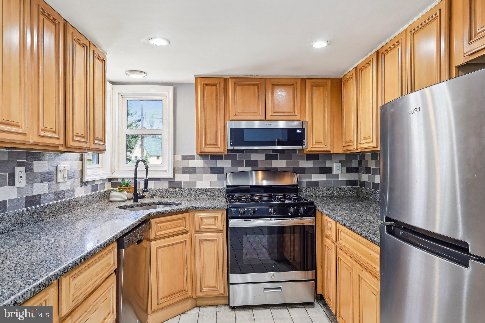96 East 9th Avenue Pine Hill, NJ 08021 - Photo 12 of 31 a kitchen with granite countertop a refrigerator stove and sink