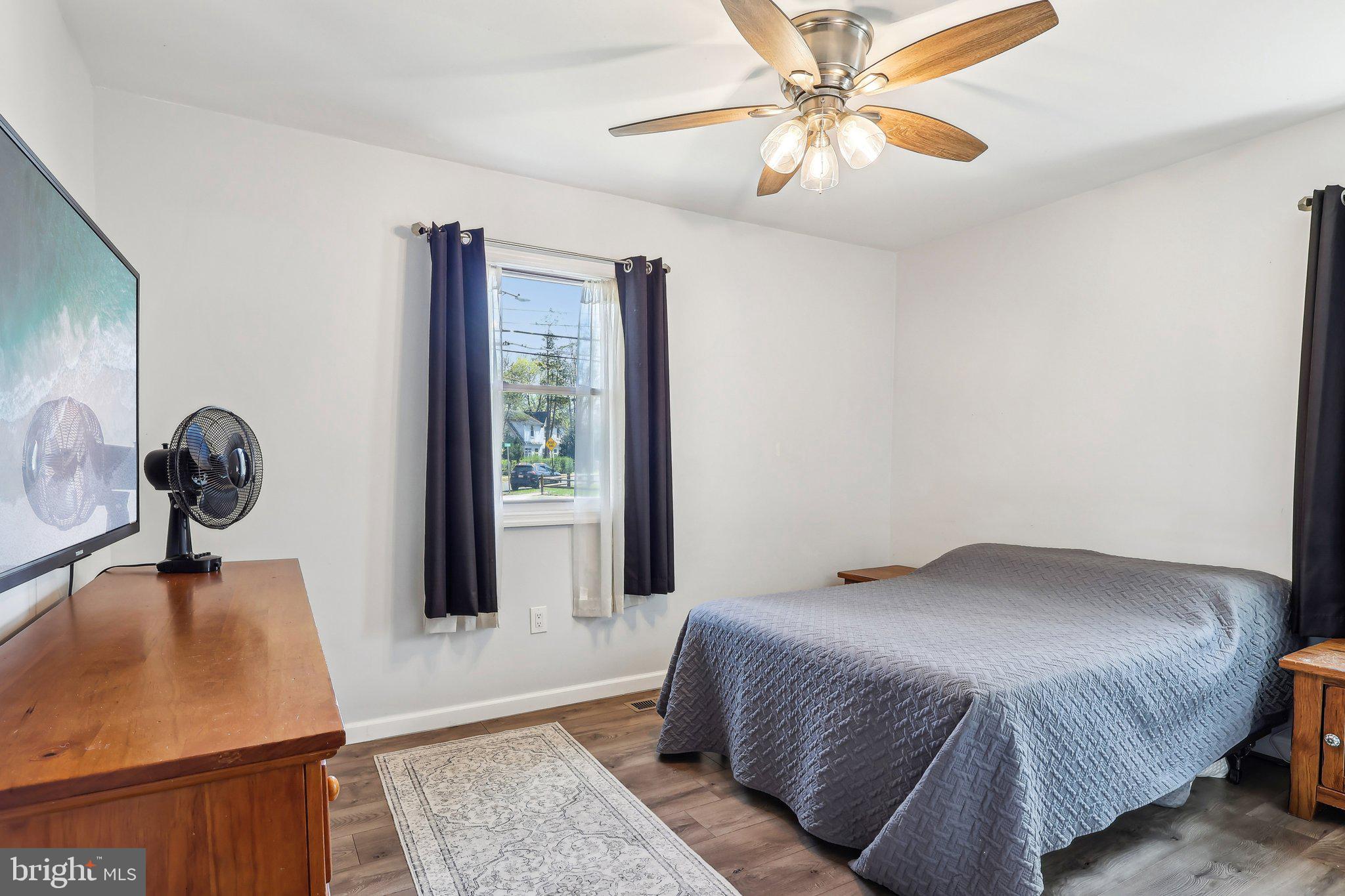 96 East 9th Avenue Pine Hill, NJ 08021 - Photo 13 of 31 a bedroom with a bed and a chandelier