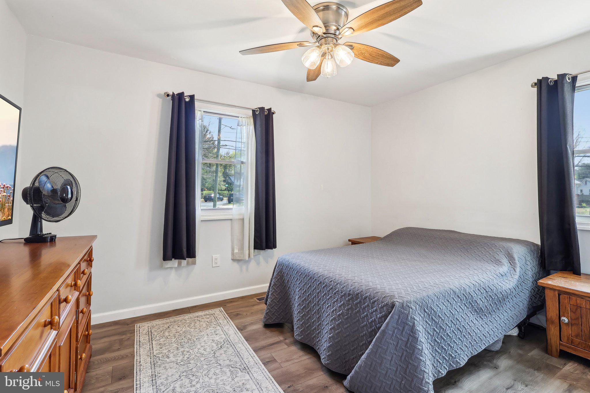 96 East 9th Avenue Pine Hill, NJ 08021 - Photo 14 of 31 a bedroom with a bed and a chandelier