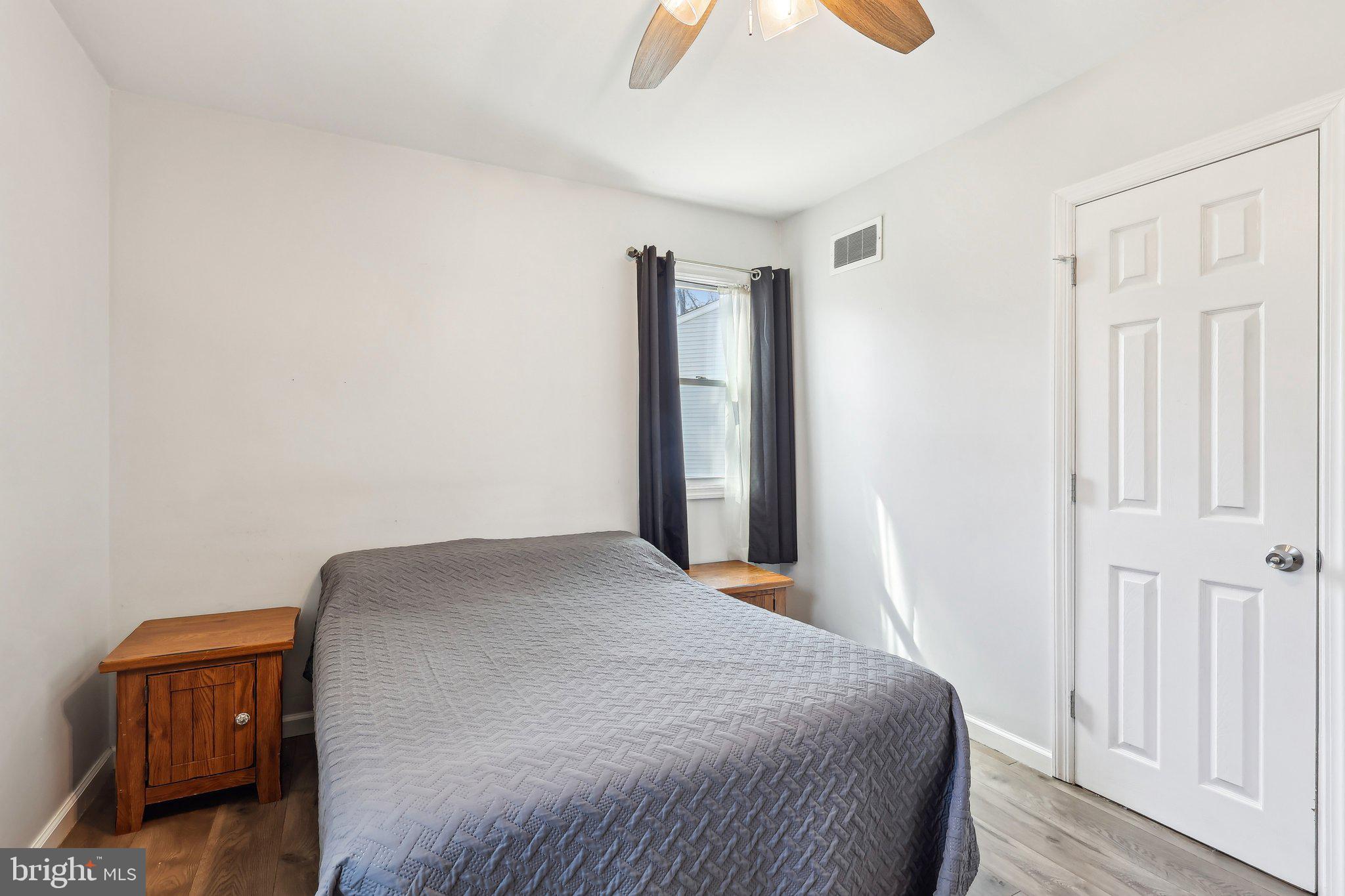96 East 9th Avenue Pine Hill, NJ 08021 - Photo 15 of 31 a bedroom with a bed and wooden floor