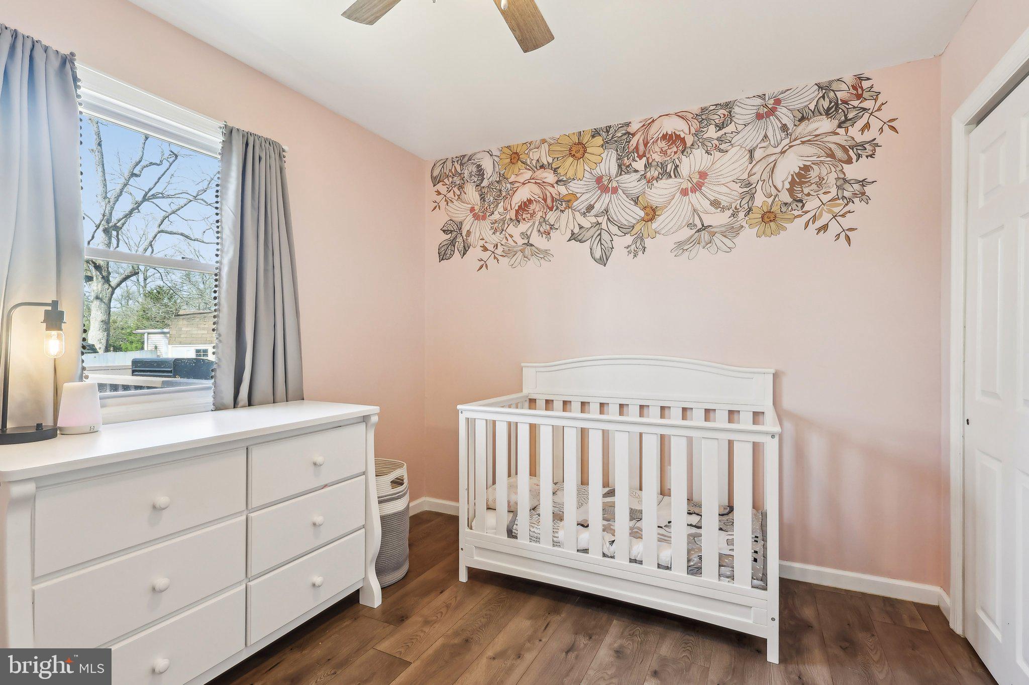 96 East 9th Avenue Pine Hill, NJ 08021 - Photo 16 of 31 a bedroom with a baby bed toys and a window