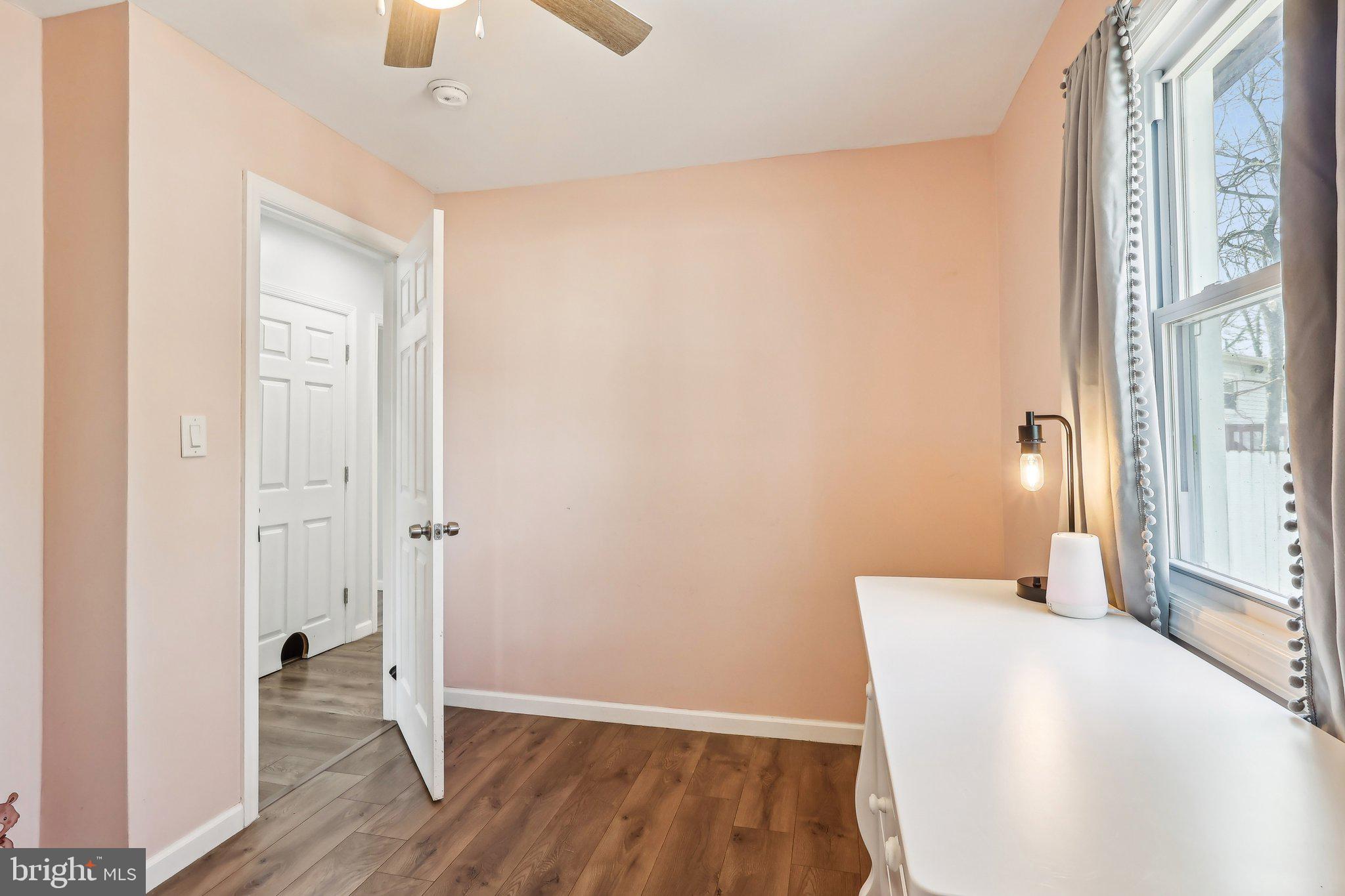96 East 9th Avenue Pine Hill, NJ 08021 - Photo 17 of 31 a bedroom with wooden floor and a ceiling fan