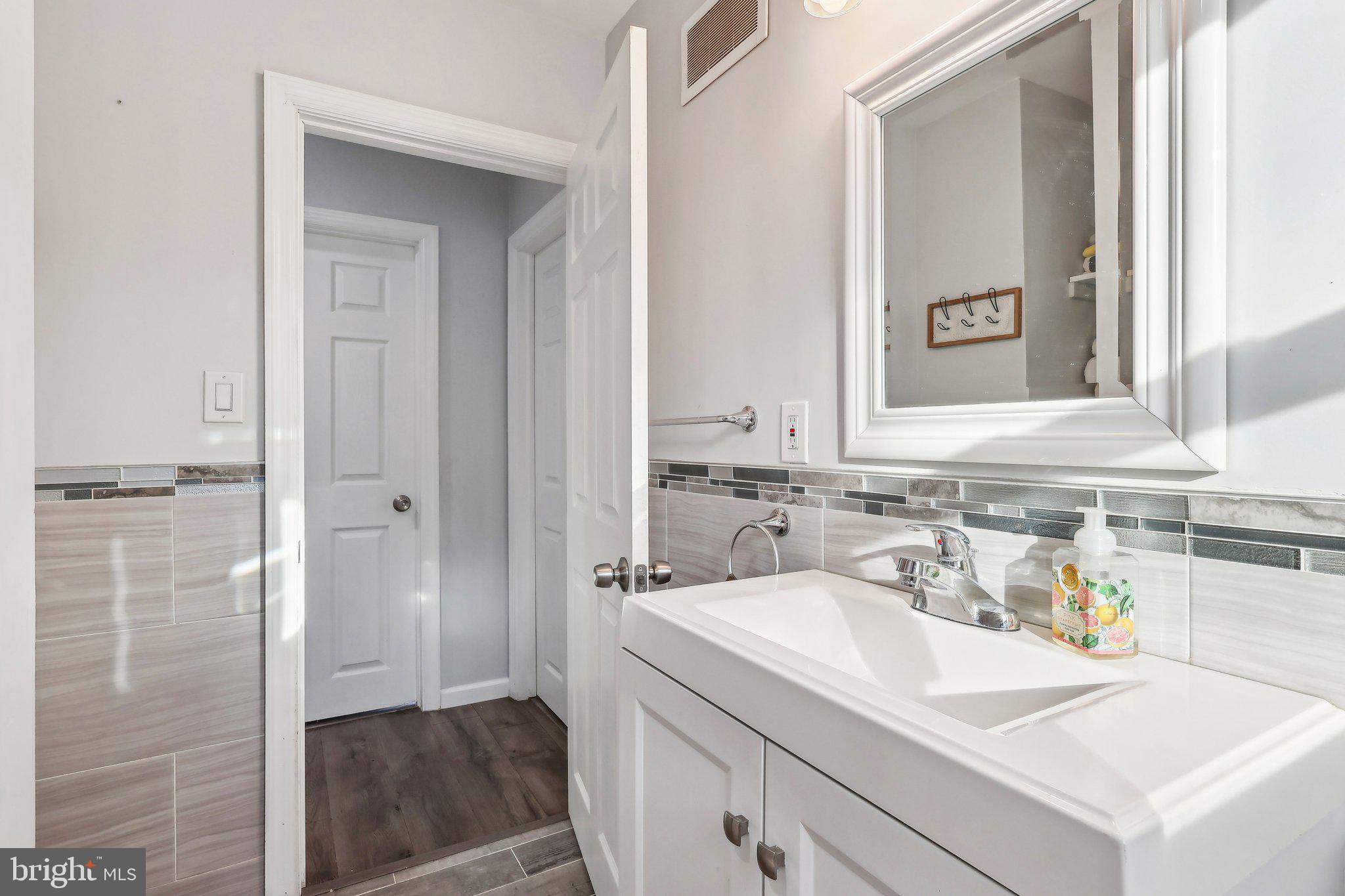 96 East 9th Avenue Pine Hill, NJ 08021 - Photo 21 of 31 a bathroom with a sink and a mirror