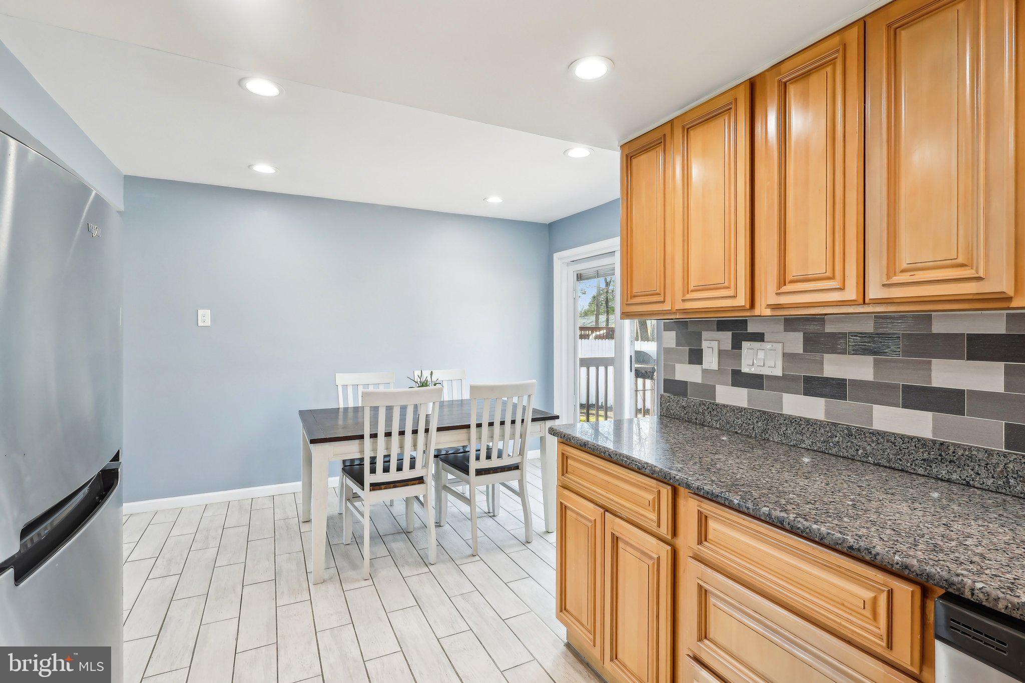96 East 9th Avenue Pine Hill, NJ 08021 - Photo 9 of 31 a kitchen with stainless steel appliances granite countertop wooden cabinets a sink and a stove