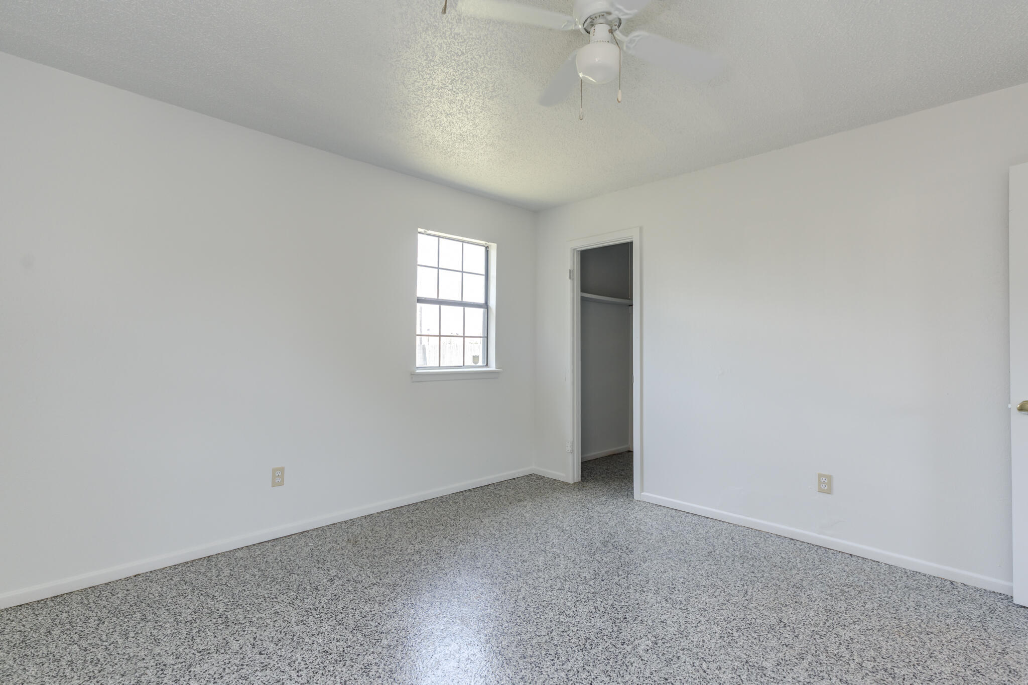1313 Adrian Street Lubbock, TX 79403 - Photo 17 of 26 an empty room with windows and fan view