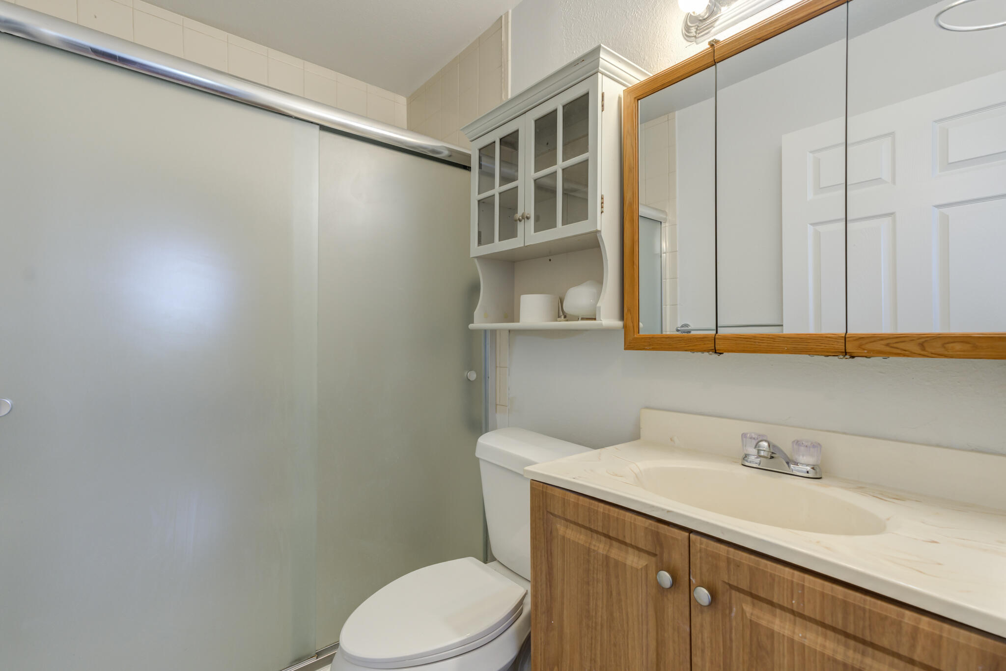 1313 Adrian Street Lubbock, TX 79403 - Photo 18 of 26 a bathroom with a sink a toilet and vanity