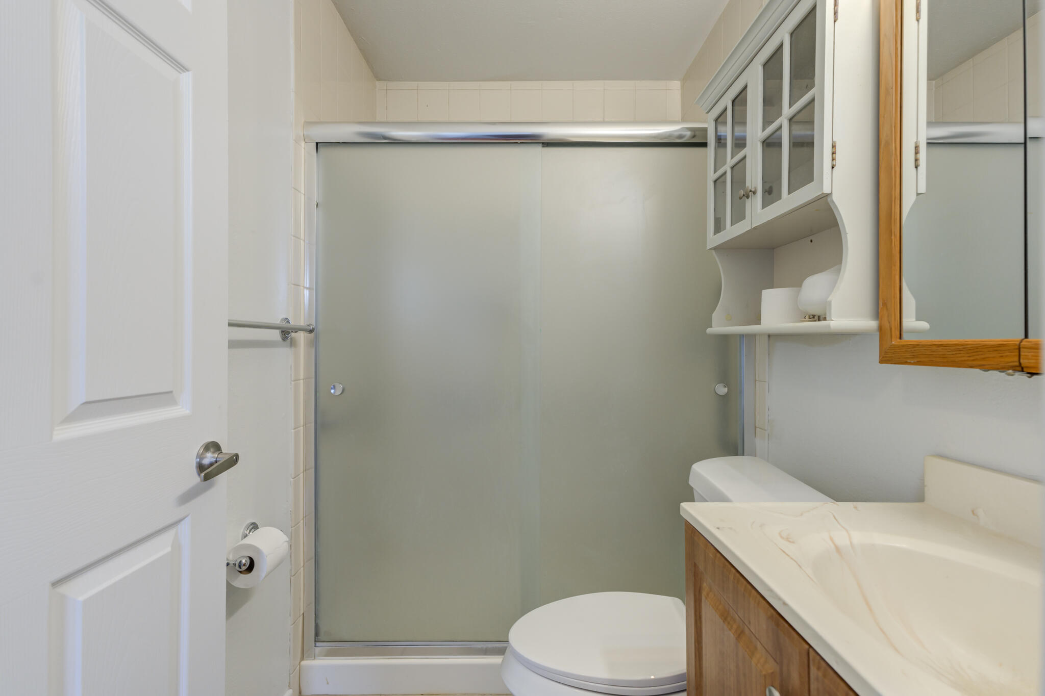 1313 Adrian Street Lubbock, TX 79403 - Photo 19 of 26 a white toilet sitting next to a bathroom sink