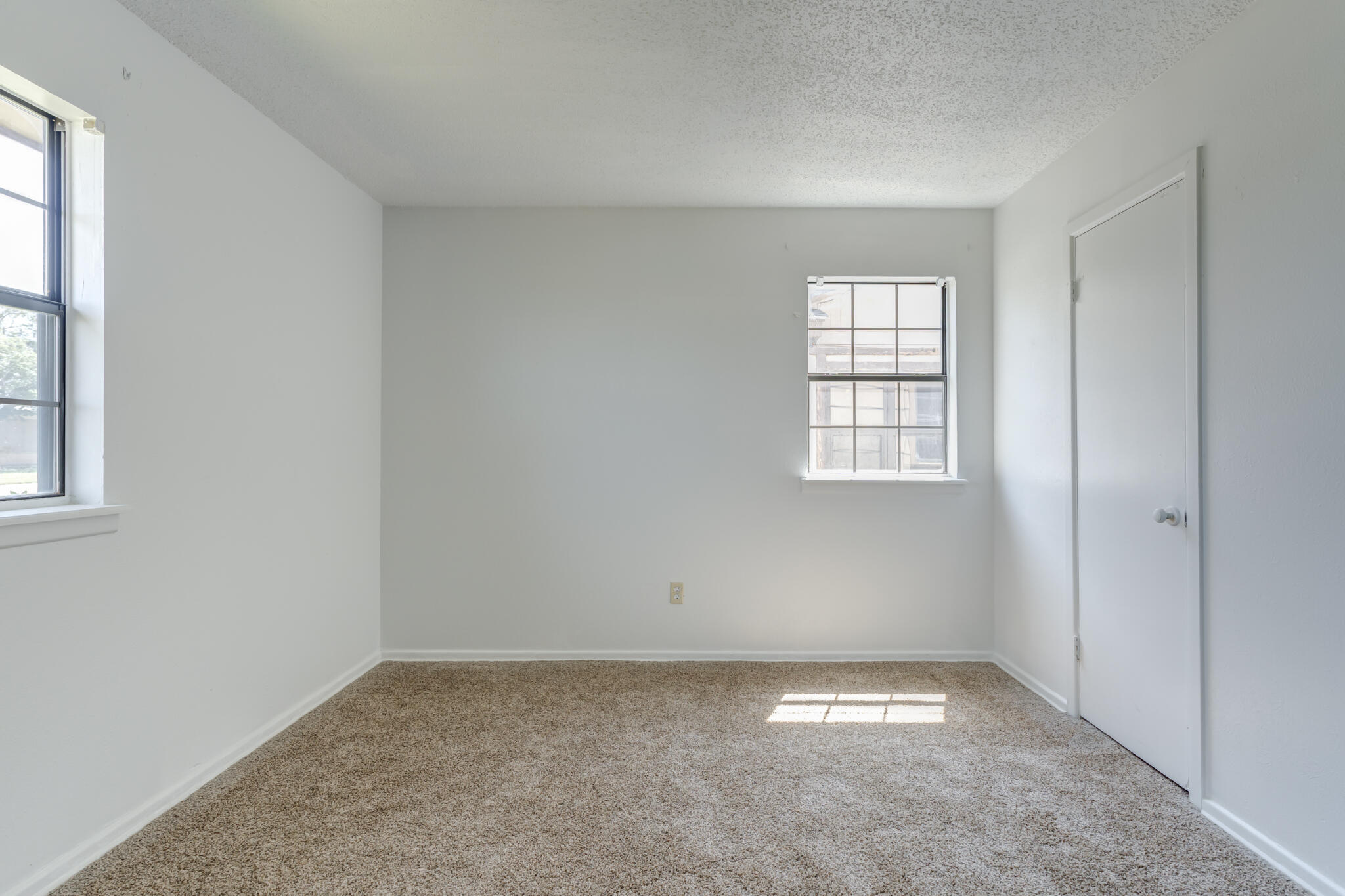 1313 Adrian Street Lubbock, TX 79403 - Photo 23 of 26 an empty room with a window