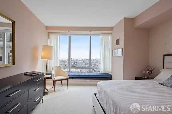 a bedroom with a bed and a night stand