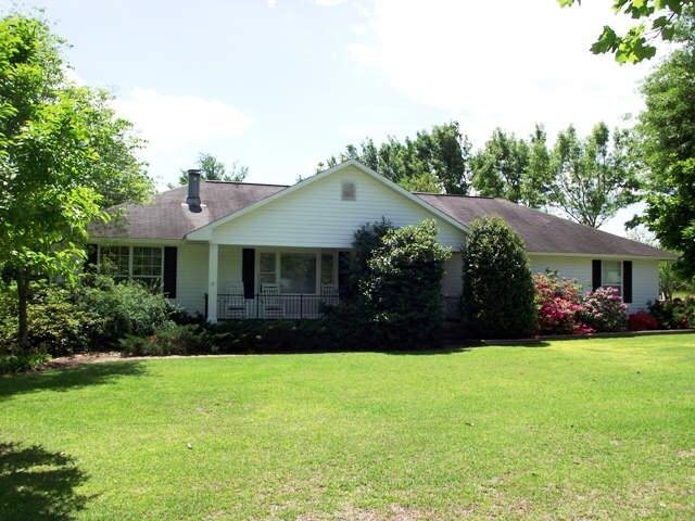 a front view of house with yard and green space