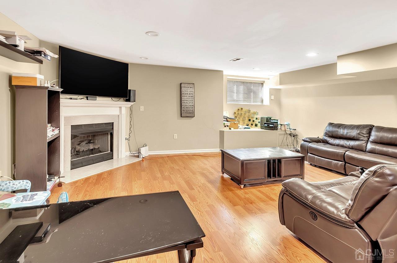 5 Rondell Lane, Unit 198 Old Bridge, NJ 08879 - Photo 11 of 23 a living room with furniture and a flat screen tv