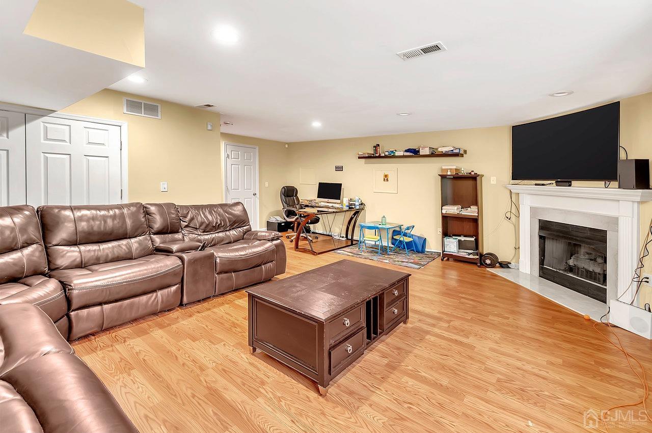 5 Rondell Lane, Unit 198 Old Bridge, NJ 08879 - Photo 12 of 23 a living room with furniture fireplace and flat screen tv