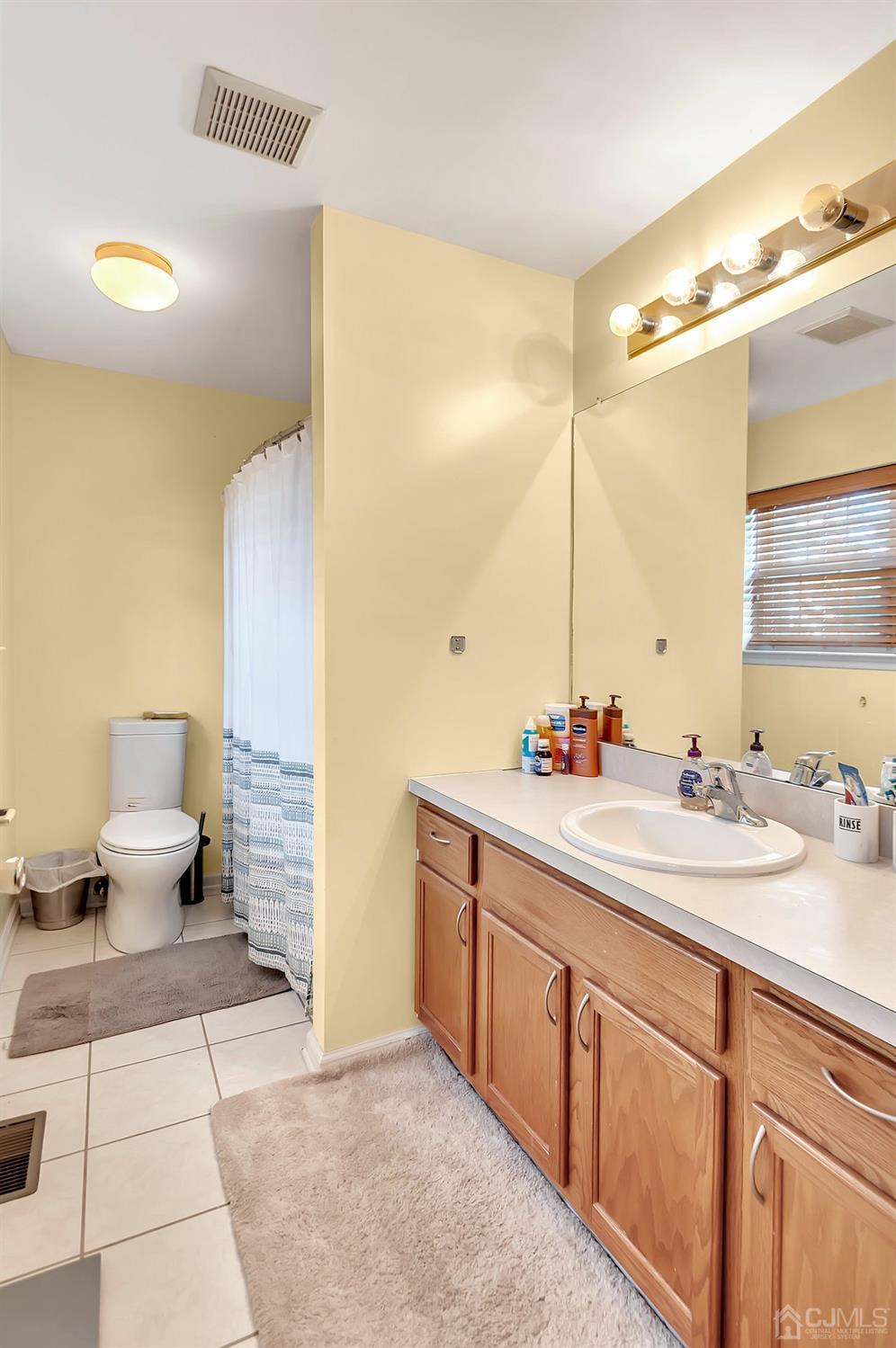 5 Rondell Lane, Unit 198 Old Bridge, NJ 08879 - Photo 15 of 23 a spacious bathroom with a double vanity sink mirror and toilet