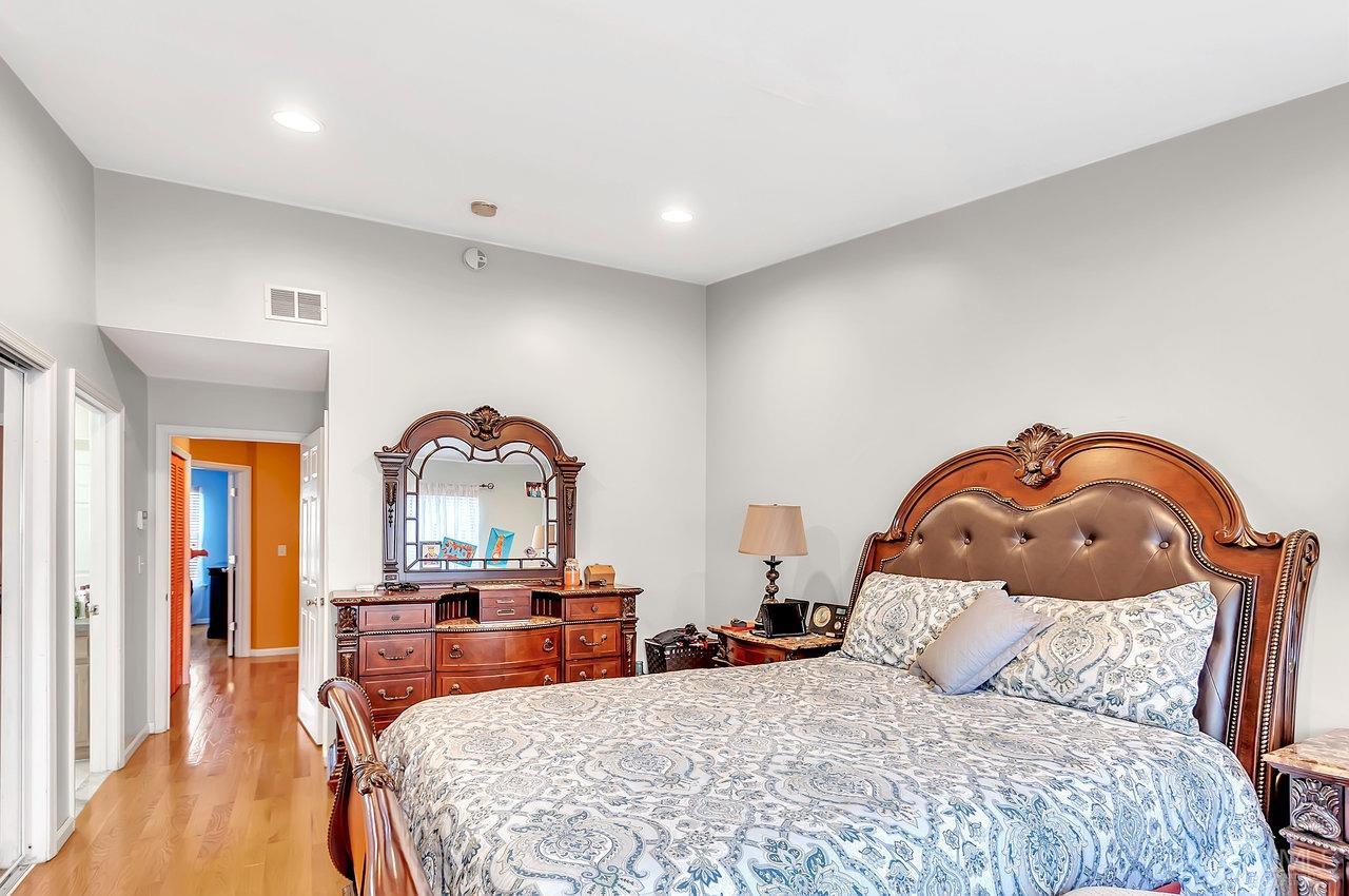 5 Rondell Lane, Unit 198 Old Bridge, NJ 08879 - Photo 17 of 23 a bedroom with a bed a table and a mirror