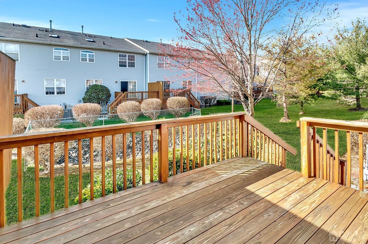 5 Rondell Lane, Unit 198 Old Bridge, NJ 08879 - Photo 20 of 23 a view of a deck with wooden floor and fence next to a yard
