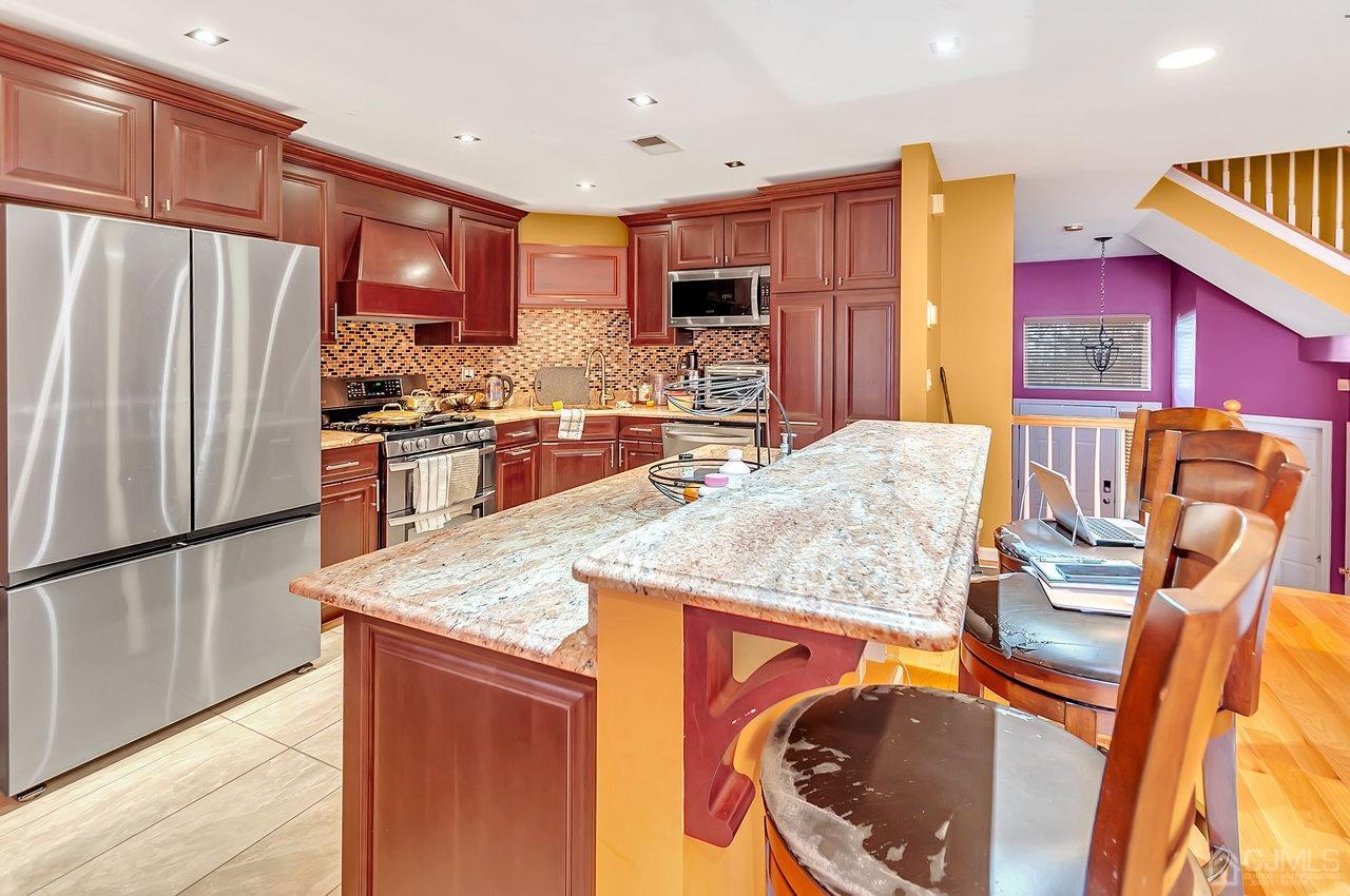 5 Rondell Lane, Unit 198 Old Bridge, NJ 08879 - Photo 6 of 23 a kitchen with stainless steel appliances granite countertop a refrigerator a stove top oven a sink and dishwasher