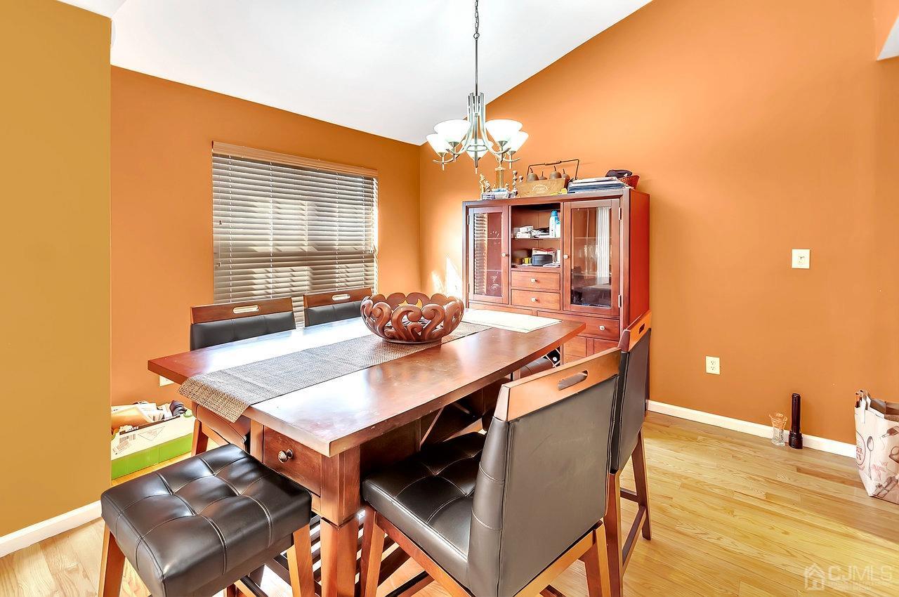 5 Rondell Lane, Unit 198 Old Bridge, NJ 08879 - Photo 8 of 23 a view of a dining room with furniture and wooden floor