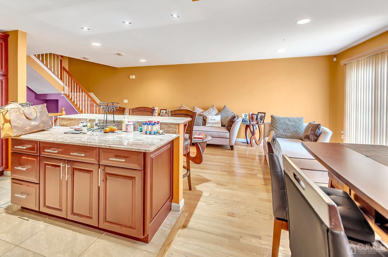 5 Rondell Lane, Unit 198 Old Bridge, NJ 08879 - Photo 9 of 23 a kitchen with stainless steel appliances kitchen island granite countertop a sink and cabinets