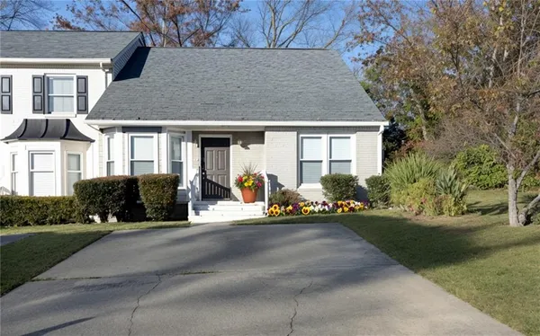 a front view of a house with a yard and outdoor seating