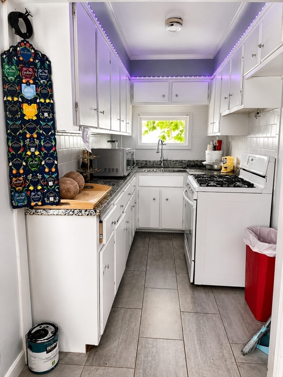 280 Ridge Street Fall River, MA 02721 - Photo 6 of 7 a kitchen with a sink stove and cabinets