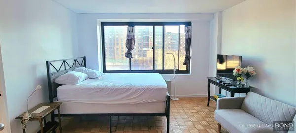 a bedroom with a bed and a chair