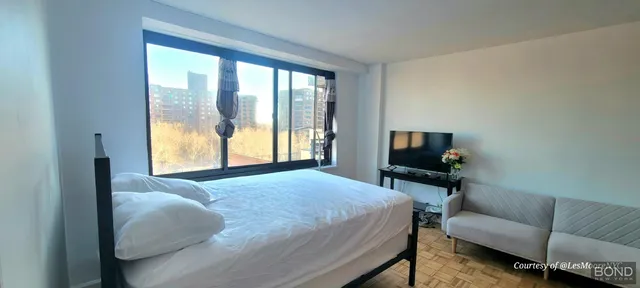 a bedroom with a bed and a couch